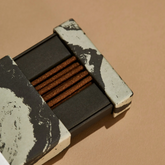 Open box of Palo Santo incense to show the brown sticks. 