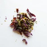 A small pile of the Dream Tea herbal blend on a white surface.