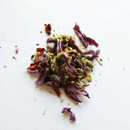 A small pile of the Dream Tea herbal blend on a white surface.