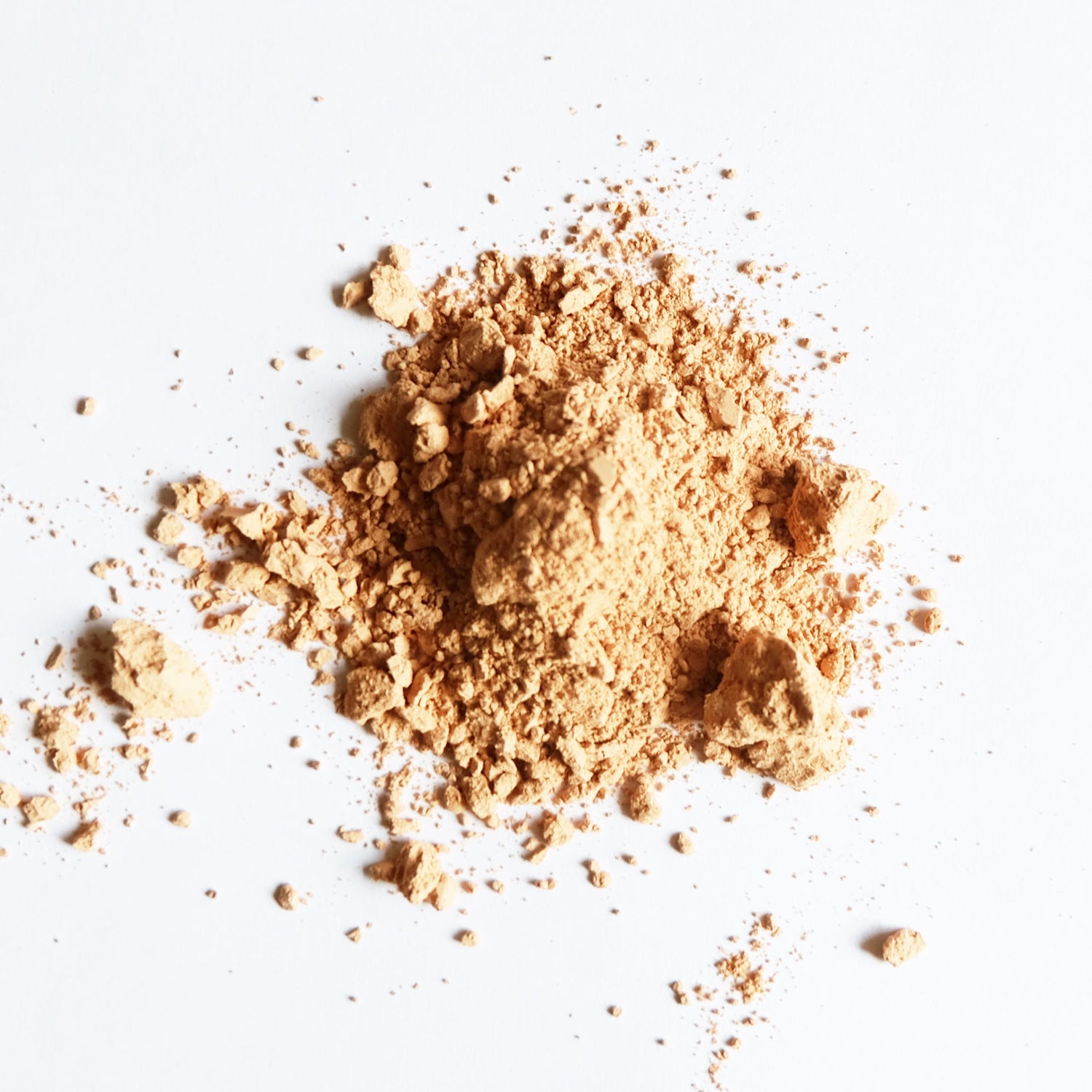 A pile of pink clay powder on a white bench. 