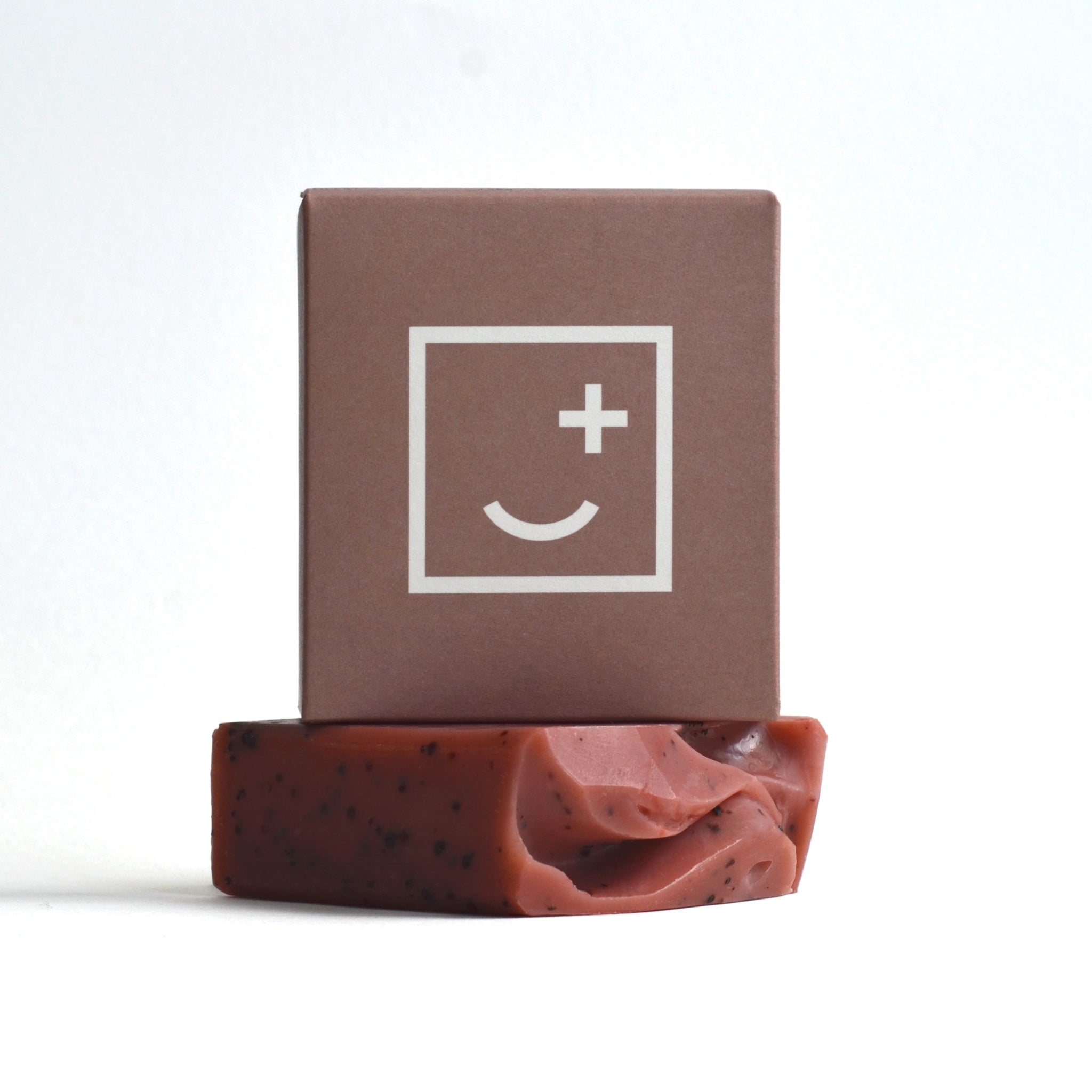 A dark rose coloured soap bar and box made by Fair + Square.